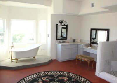A bathroom with a tub and a rug.